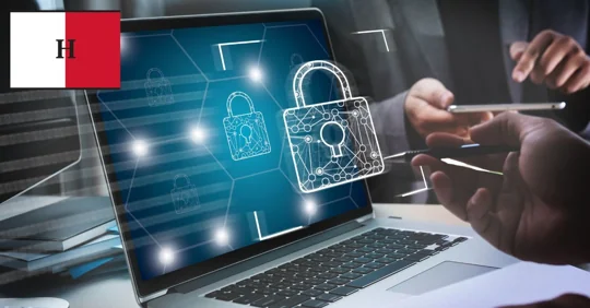 Laptop with digital lock icon, two people discussing cybersecurity.