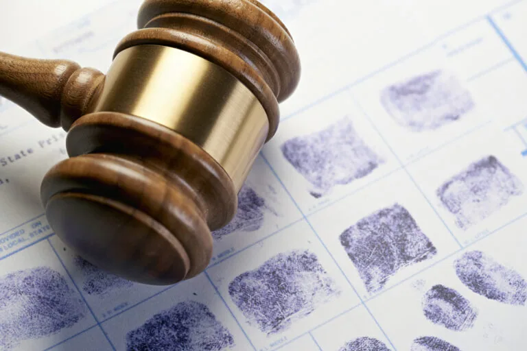 Gavel on fingerprints document